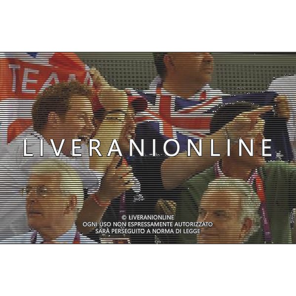 (left to right) Prince Harry with cousin Peter Phillips and Lord Seb Coe (right), cheer on Laura Trott as they watch the action in the Olympic Velodrome in Stratford east London. Tuesday August 7, 2012. AG ALDO LIVERANI S A S ONLY ITALY