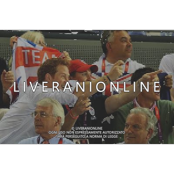 (left to right) Prince Harry with cousin Peter Phillips and Lord Seb Coe (right), cheer on Laura Trott as they watch the action in the Olympic Velodrome in Stratford east London. Tuesday August 7, 2012. AG ALDO LIVERANI S A S ONLY ITALY