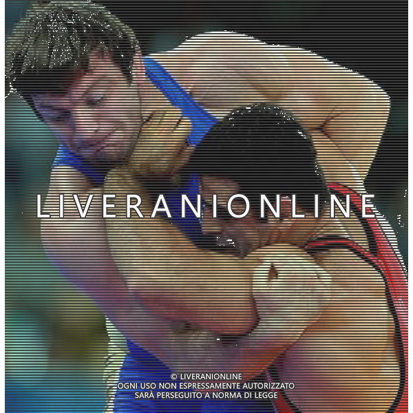 (120807) -- LONDON, Aug. 7, 2012 () -- Ghasem Gholamreza Rezaei of Iran (in red) competes with Rustam Totrov of Russia during men\'s wrestling Greco-Roman 96kg gold medal contest, at London 2012 Olympic Games in London, Britain, on August 7, 2012. Ghasem Gholamreza Rezaei of Iran won. (/Gesang Dawa) (nxl) AG ALDO LIVERANI S A S ONLY ITALY