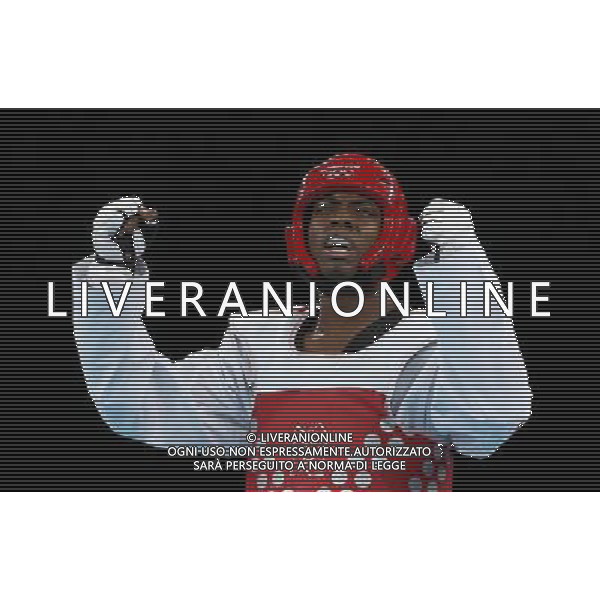 (120810) -- LONDON, Aug. 10, 2012 () -- Lutalo Muhammad of Britain (red) celebrates after winning over Arman Yeremyan of Armenia during the bronze medal match of men\'s Taekwondo -80kg event at London 2012 Olympic Games in London, Britain, on August 10, 2012. Lutalo Muhammad of Britain won the match and claimed the bronze medal of the event. (/Wang Lili) AG ALDO LIVERANI S A S ONLY ITALY