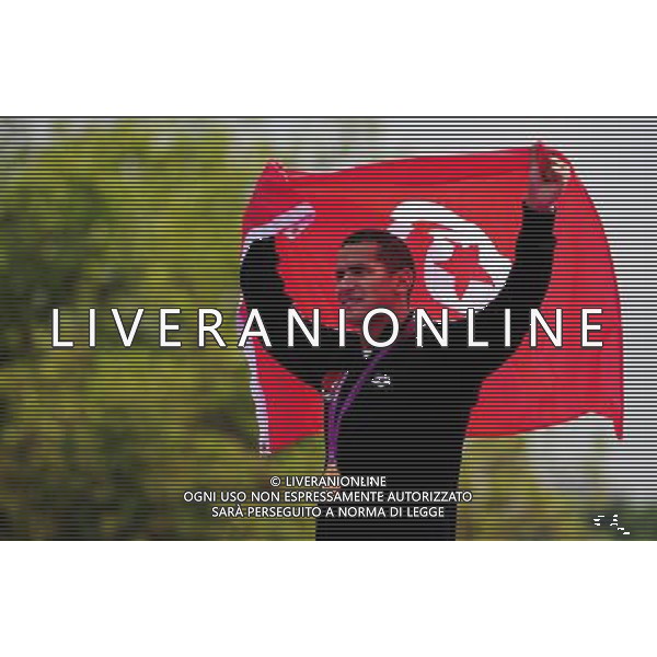 (120810) -- LONDON, Aug. 10, 2012 () -- Gold medalist Oussama Mellouli of Tunisia celebrates during victory ceremony of men\'s swimming 10km marathon, at London 2012 Olympic Games in London, Britain, on August 10, 2012. (/Tao Xiyi) (nxl) ITALY ONLY - GIOCHI OLIMPICI, OLIMPIADI LONDRA 2012