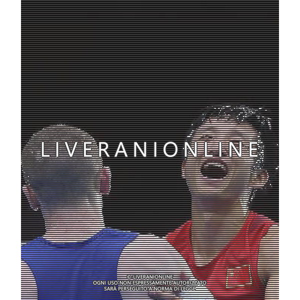 (120810) -- LONDON, Aug. 10, 2012 () -- Zou Shiming of China (in red) celebrates after defeating Paddy Barnes of Ireland during men\'s Light Fly (46-49kg) semifinals match, at London 2012 Olympic Games in London, Britain, on August 10, 2012. Zou Shiming of China advanced to the final. (/Wang Shen) (nxl) ITALY ONLY - GIOCHI OLIMPICI, OLIMPIADI LONDRA 2012