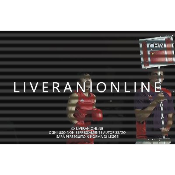 (120810) -- LONDON, Aug. 10, 2012 () -- Zou Shiming of China (in red) enters for men\'s Light Fly (46-49kg) semifinals match between him and Paddy Barnes of Ireland, at London 2012 Olympic Games in London, Britain, on August 10, 2012. Zou Shiming of China advanced to the final. (/Wang Shen) (nxl) ITALY ONLY - GIOCHI OLIMPICI, OLIMPIADI LONDRA 2012