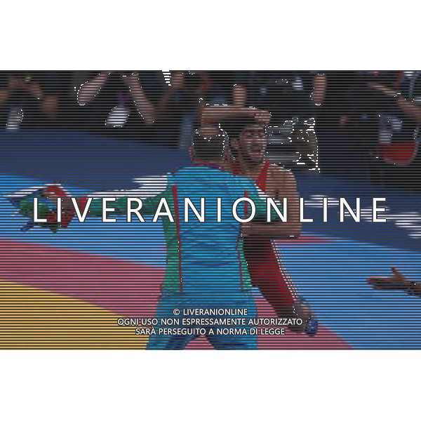 (120811) -- LONDON, Aug. 11, 2012 () -- Toghrul Asgarov of Azerbaijan (red) celebrates after winning over Besik Kudukhov of Russia during the Men\'s 60kg Freestyle gold medal match of Wrestling at London 2012 Olympic Games, London, Britain, Aug. 11, 2012. Toghrul Asgarov of Azerbaijan won the match and claimed the gold medal of the event. (/Jin Liwang) ITALY ONLY - GIOCHI OLIMPICI, OLIMPIADI LONDRA 2012