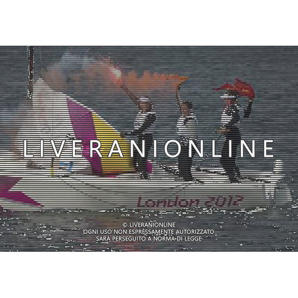 (120811) -- LONDON, Aug. 11, 2012 () -- Members of the Spanish team celebrate after Elliott 6m WMR competition of Sailing event, at London 2012 Olympic Games in Britain, on August 11, 2012. The Spanish team won gold medal. (/Fei Maohua) (nxl) ITALY ONLY - GIOCHI OLIMPICI, OLIMPIADI LONDRA 2012