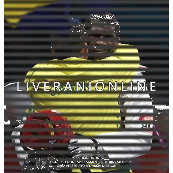 (120811) -- LONDON, Aug. 11, 2012 () -- Anthony Obame of Gabon hugs his coach after defeating Bahri Tanrikulu of Turkey in men\'s Taekwondo +80kg semifinal match, at London 2012 Olympic Games in London, Britain, on August 11, 2012. (/Wang Lili) (nxl) ITALY ONLY - GIOCHI OLIMPICI, OLIMPIADI LONDRA 2012