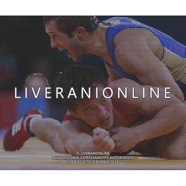 (120811) -- LONDON, Aug. 11, 2012 () -- Besik Kudukhov of Russia (blue) competes with Ri Jong Myong of the Democratic People\'s Republic of Korea (DPRK) during the Men\'s 60kg Freestyle of Wrestling at London 2012 Olympic Games, London, Britain, Aug. 11, 2012. Besik Kudukhov of Russia won the match and advanced to final. (/Ren Zhenglai) ©PHOTOSHOT/Agenzia Aldo Liverani Sas - ITALY ONLY - GIOCHI OLIMPICI, OLIMPIADI LONDRA 2012