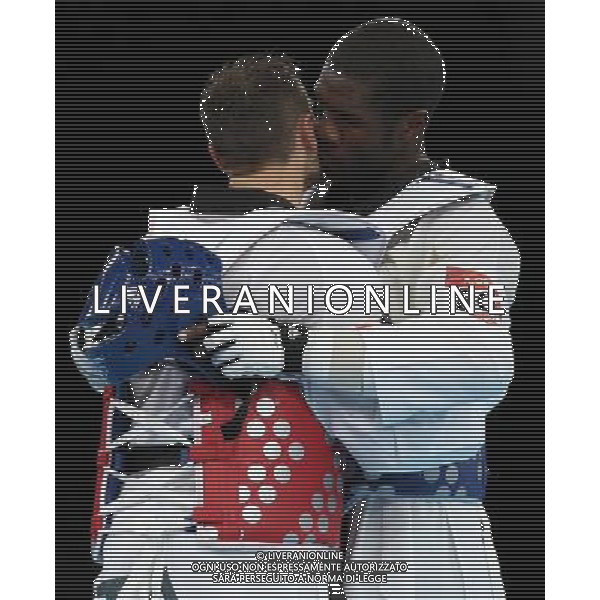 (120811) -- LONDON, Aug. 11, 2012 () -- Carlo Molfetta of Italy (red) hugs Anthony Obame of Gabon after the gold medal match of men\'s +80kg Taekwondo at London 2012 Olympic Games, London, Britain, Aug. 11, 2012. Carlo Molfetta of Italy won the match and claimed the gold medal of the event. (/Wang Lili) ©PHOTOSHOT/Agenzia Aldo Liverani Sas - ITALY ONLY - GIOCHI OLIMPICI, OLIMPIADI LONDRA 2012