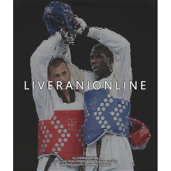 (120811) -- LONDON, Aug. 11, 2012 () -- Carlo Molfetta of Italy (red) hugs Anthony Obame of Gabon after the gold medal match of men\'s +80kg Taekwondo at London 2012 Olympic Games, London, Britain, Aug. 11, 2012. Carlo Molfetta of Italy won the match and claimed the gold medal of the event. (/Wang Lili) ©PHOTOSHOT/Agenzia Aldo Liverani Sas - ITALY ONLY - GIOCHI OLIMPICI, OLIMPIADI LONDRA 2012
