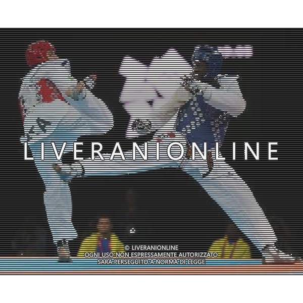 (120811) -- LONDON, Aug. 11, 2012 () -- Carlo Molfetta of Italy (red) competes with Anthony Obame of Gabon during Bahri Tanrikulu of Turkey during the gold medal match of men\'s +80kg Taekwondo at London 2012 Olympic Games, London, Britain, Aug. 11, 2012. Carlo Molfetta of Italy won the match and claimed the gold medal of the event. (/Wang Lili) ©PHOTOSHOT/Agenzia Aldo Liverani Sas - ITALY ONLY - GIOCHI OLIMPICI, OLIMPIADI LONDRA 2012