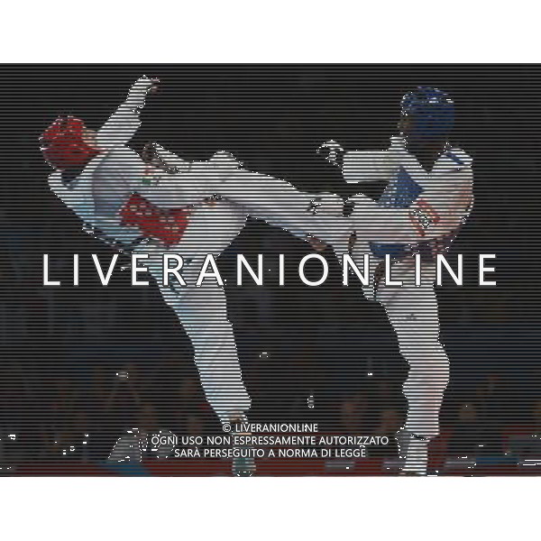 (120811) -- LONDON, Aug. 11, 2012 () -- Carlo Molfetta of Italy (red) competes with Anthony Obame of Gabon during Bahri Tanrikulu of Turkey during the gold medal match of men\'s +80kg Taekwondo at London 2012 Olympic Games, London, Britain, Aug. 11, 2012. Carlo Molfetta of Italy won the match and claimed the gold medal of the event. (/Li Ga) ©PHOTOSHOT/Agenzia Aldo Liverani Sas - ITALY ONLY - GIOCHI OLIMPICI, OLIMPIADI LONDRA 2012
