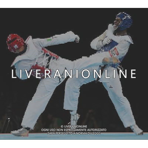 (120811) -- LONDON, Aug. 11, 2012 () -- Carlo Molfetta of Italy (red) competes with Anthony Obame of Gabon during Bahri Tanrikulu of Turkey during the gold medal match of men\'s +80kg Taekwondo at London 2012 Olympic Games, London, Britain, Aug. 11, 2012. Carlo Molfetta of Italy won the match and claimed the gold medal of the event. (/Wang Lili) ©PHOTOSHOT/Agenzia Aldo Liverani Sas - ITALY ONLY - GIOCHI OLIMPICI, OLIMPIADI LONDRA 2012