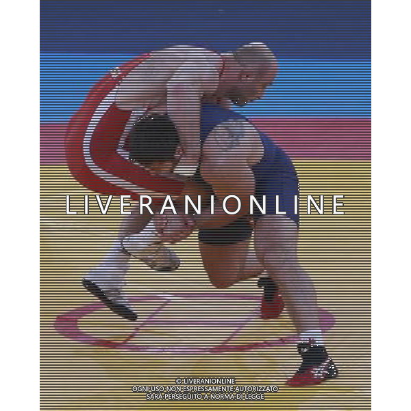 (120811) -- LONDON, Aug. 11, 2012 () -- Artur Taymazov of Uzbekistan (red) competes with Davit Modzmanashvili of Georgia during the Men\'s 120kg Freestyle gold medal match of Wrestling at London 2012 Olympic Games, London, Britain, Aug. 11, 2012. Artur Taymazov of Uzbekistan won the match and claimed the gold medal of the event. (/Jin Liwang) ©PHOTOSHOT/Agenzia Aldo Liverani Sas - ITALY ONLY - GIOCHI OLIMPICI, OLIMPIADI LONDRA 2012