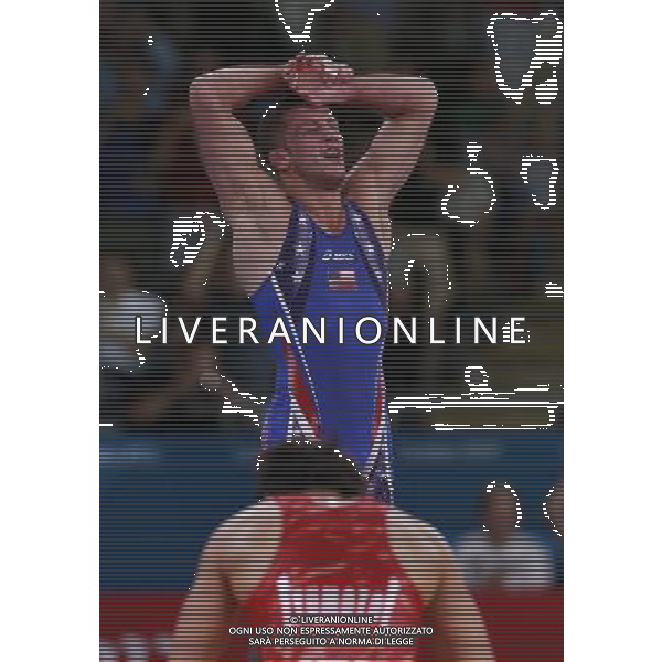 (120811) -- LONDON, Aug. 11, 2012 () -- Coleman Scott of the United States (blue) celebrates after winning over Kenyichi Yumoto of Japan during the Men\'s 60kg Freestyle bronze medal match of Wrestling at London 2012 Olympic Games, London, Britain, Aug. 11, 2012. Coleman Scott of the United States won the match and claimed the bronze medal of the event. (/Ren Zhenglai) ©PHOTOSHOT/Agenzia Aldo Liverani Sas - ITALY ONLY - GIOCHI OLIMPICI, OLIMPIADI LONDRA 2012