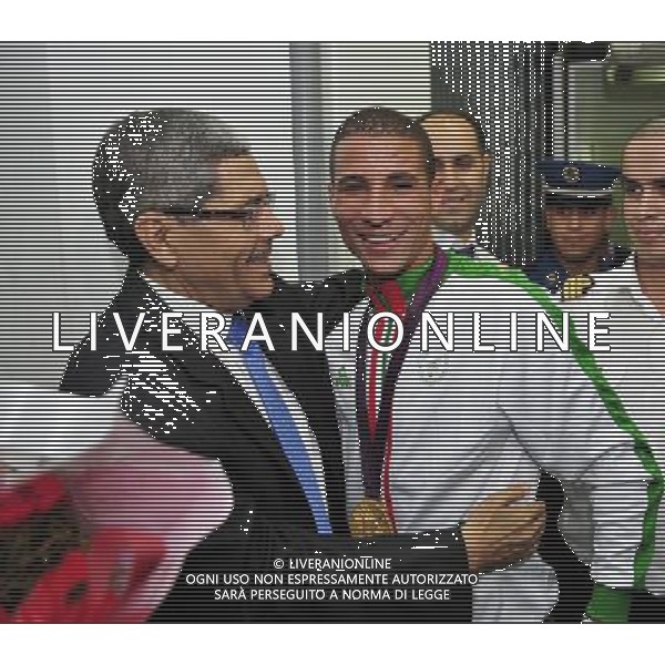 (120814) -- ALGERIA , Aug. 14, 2012 () -- The Algerian Olympic champion Toufik Mekhloufi is welcomed by Algerian Minister of Youth and Sports, Hachemi Djiar (L)after his arrival at the international airport Houari Boumediene in Algiers, Algeria, on August 13, 2012. The Algerian middle-distance runner won the 1500m golden medal in London Olympics on August 7, the sole gold medal for the North African nation. (/Mohamed Kadri) ©photoshot/Agenzia Aldo Liverani Sas - ITALY ONLY - Il campione olimpico algerino Toufik Mekhloufi mezzofondista medaglia d\'oro 1500m alle Olimpiadi al suo arrivo all\'aeroporto internazionale Houari Boumediene di Algeri, in Algeria 13 agosto 2012.