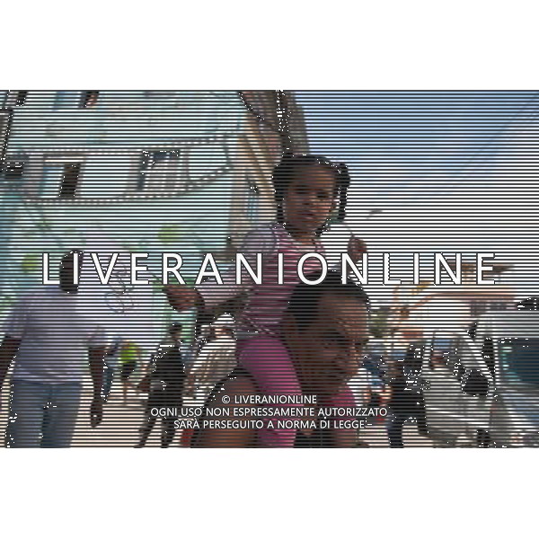 (120816) -- RIO DE JANEIRO, Aug. 16, 2012 () -- A little girl is seen during the ceremony in Complexo do Alemao slum of Rio de Janeiro, Brazil, Aug. 15, 2012. A ceremony was held here to mark the arrival of the flag in Rio de Janeiro, the host city of 2016 Summer Olympic Games. (/Weng Xinyang) (jyc) ©photoshot/AGENZIA ALDO LIVERANI SAS - ITALY ONLY - Cerimonia per celebrare l\'arrivo della bandiera Olimpica a Rio de Janeiro, la citta\' ospite dei Giochi Olimpici estivi 2016, Brasile, 15 agosto, 2012.