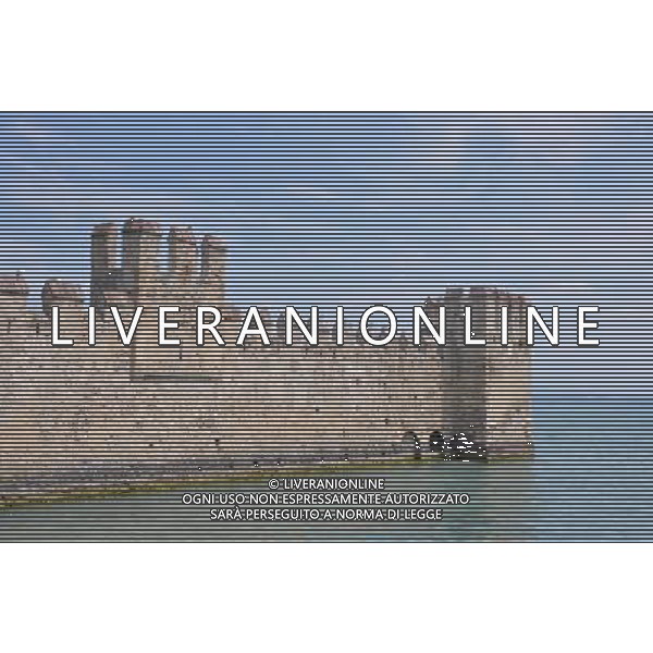 (120815) -- SIRMIONE, Aug. 15, 2012 () -- The dock of Scaliger Castle is seen in the photo taken in Sirmione, Italy, on Aug. 12, 2012. The Scaliger Castle is located in the Italian lakeside town of Sirmione. Sirmione has a beautiful historic center which is situated on top of a small peninsula that just out into the southern portion of Lake Garda. Built in the 13th century by the Scaliger family, the Scaliger Castle is considered one of the finest examples of a medieval fortification, including a very rare fortified port. (/Song Jian) ©photoshot/Agenzia Aldo Liverani Sas - ITALY ONLY - Il Castello Scaligero di Sirmione con un bellissimo centro storico che si trova sulla cima di una piccola penisola del Lago di Garda - SIRMIONE, Italia 15 agosto 2012