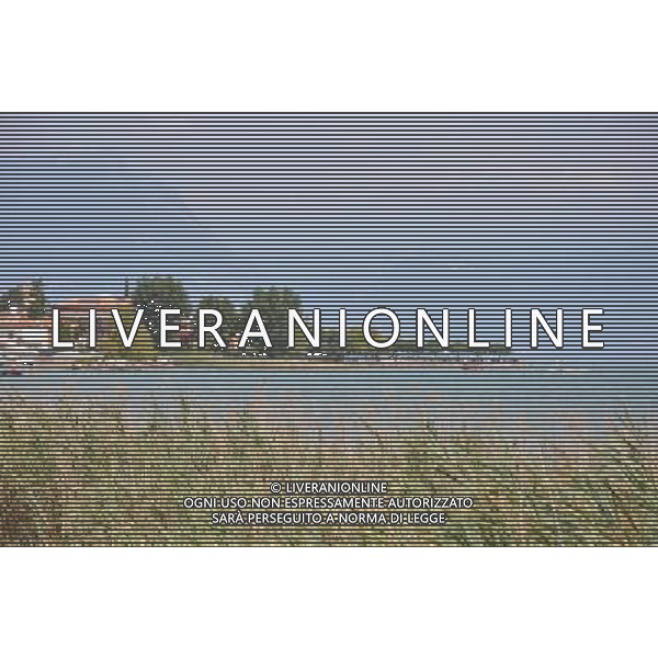 (120815) -- SIRMIONE, Aug. 15, 2012 () -- The Sirmione peninsula is seen in the photo taken in Italy, on Aug. 12, 2012. The Scaliger Castle is located in the Italian lakeside town of Sirmione. Sirmione has a beautiful historic center which is situated on top of a small peninsula that just out into the southern portion of Lake Garda. Built in the 13th century by the Scaliger family, the Scaliger Castle is considered one of the finest examples of a medieval fortification, including a very rare fortified port. (/Song Jian) ©photoshot/Agenzia Aldo Liverani Sas - ITALY ONLY - Il Castello Scaligero di Sirmione con un bellissimo centro storico che si trova sulla cima di una piccola penisola del Lago di Garda - SIRMIONE, Italia 15 agosto 2012