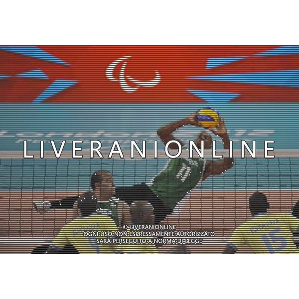 (120831) -- LONDON, Aug. 31, 2012 () -- Wescley Oliveira (Top) of Brazil saves the ball during the men\'s sitting volleyball preliminary round match against Rwanda at the London 2012 Paralympic Games, Aug. 31, 2012. Brazil won 3-0. (/Chen Yehua) (zc) AG ALDO LIVERANI S A S ONLY ITALY
