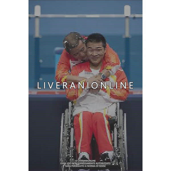 (120901) -- LONDON, Sept. 1, 2012 () -- Gold medalist Feng Qi (R) and his coach Li Weipu of China hug during the awarding ceremony for the men\'s -52kg powerlifting final at London 2012 Paralympic Games in London, Aug. 31, 2012. (/Lui Siu Wai) AG ALDO LIVERANI S A S ONLY ITALY