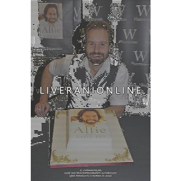 Alfie Boe at a signing of his new book \'Alfie My Story\' at Waterstones, Bluewater Shopping Centre, Greenhithe, Kent on Saturday 1 September 2012. Picture shows Alfie Boe with a cake made by \'Little Bird\'s Cake Boutique\' in Ipswich to celebrate; the launch of Alfie Boe\'s new book. AG ALDO LIVERANI S A S ONLY ITALY