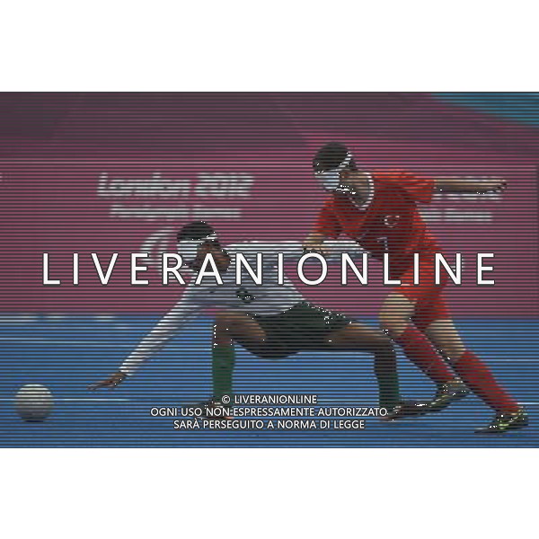(120902) -- LONDON, Sept. 2, 2012 () -- Raimundo Nonato Alves Mendes (L) of Brazil vies with Mucahit Huseyin Uslu of Turkey during the Pool B preliminary of Men\'s football 5-a-side at the London 2012 Paralympic Games in London, Britain, Sept. 2, 2012. Brazil won 4-0. (/Li Jundong) (lm) PHOTOSHOT/AG ALDO LIVERANI SAS - ITALY ONLY -