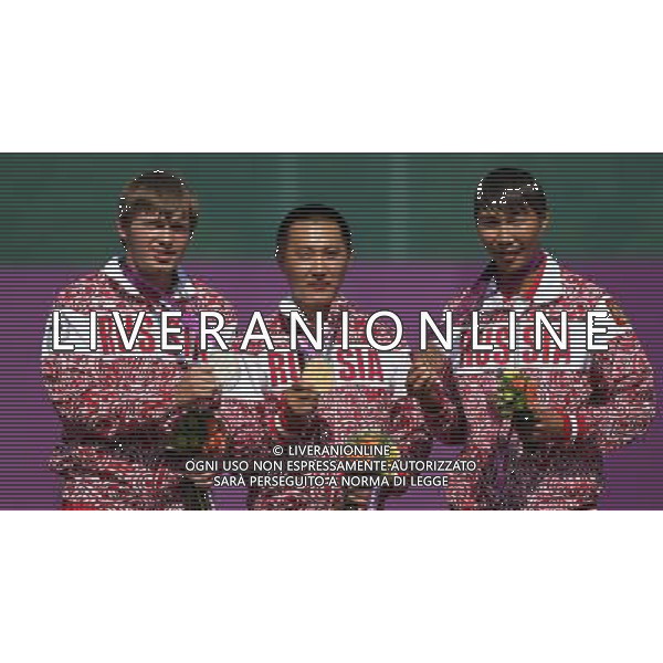 (120903) -- LONDON, Sept. 3, 2012 () -- The Russian atheletes Oleg Shestakov, Timur Tuchinov, Mikhail Oyun (L-R) pose during the awarding ceremony after the Men\'s Individual Recurve - Standing of Archery event at the London 2012 Paralympic Games in London, Britain, Sept. 3, 2012. Tuchinov (C) won the gold medal. Shestakov (L) took the silver medal. Oyun took the bronze medal. (/Wang Lili) (cc) ©PHOTOSHOT/AGENZIA ALDO LIVERANI SAS - ITALY ONLY - PARALIMPIADI LONDRA 2012
