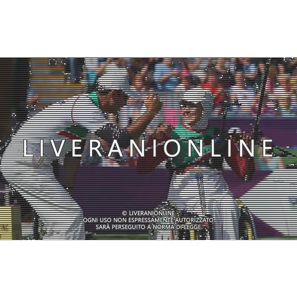 (120904) -- LONDON, Sept. 4, 2012 () -- Zahra Memati (R) of Iran and his coach celebrate victory after the Women\'s Individual Recurve - W1/W2 archery competition against Elisabetta Mijno of Italy at the London 2012 Paralympic Games in London, Britain, on Sept. 4, 2012. Memati won 7-3 to take the gold medal. (/Wang Lili) photoshot/AG ALDO LIVERANI SAS - ITALY ONLY - *** Local Caption *** ..