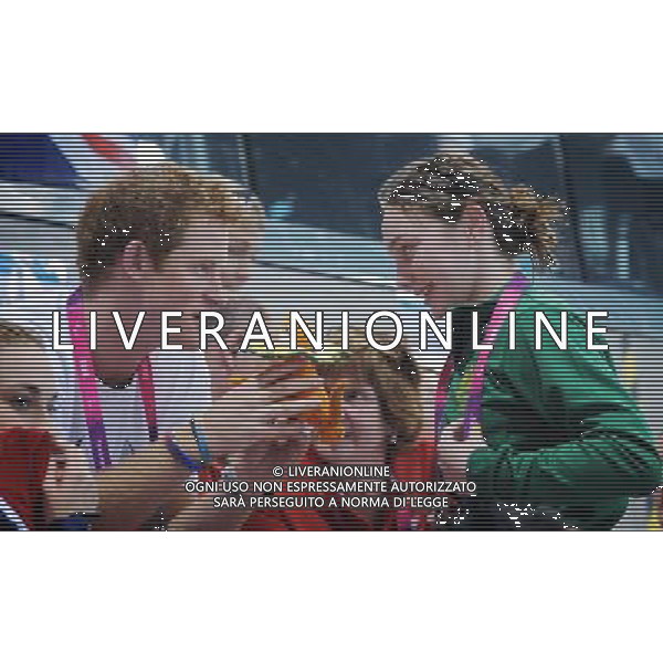 Prince Harry is given a mascot from an Australian Paralympic swimmer (name not available) when he visited the Aquatics Centre during the London 2012 Paralympic Games at the Olympic Park this morning. PHOTOSHOT/AG ALDO LIVERANI SAS - ITALY ONLY -