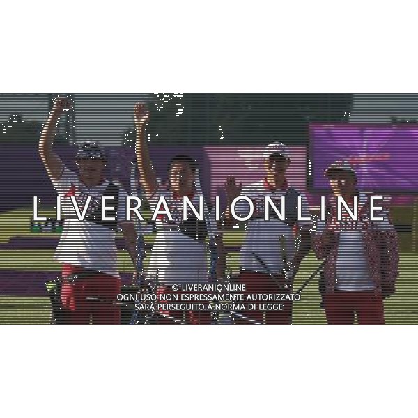 (120905) -- LONDON , Sept. 5, 2012 () -- Mikhail Oyun (2nd R), Oleg Shestakov (1st L), Timur Tuchinov (2nd L) and the coach of gold medalist team Russia greet the audience after winning the men\'s team recurve open final of archery competition at the London 2012 Paralympic Games in London, Britain, on Sept. 5, 2012. (/Wang Lili) (lm) PHOTOSHOT-AG ALDO LIVERANI SAS - ITALY ONLY