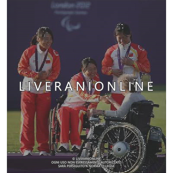 (120905) -- LONDON , Sept. 5, 2012 () -- Margaret Maughan (below R), Britain\'s first gold medal winner at the inaugural 1960 Rome Paralympics and lit the cauldron at the opening ceremony of the 2012 Summer Paralympics, shakes hands with Xiao Yanhong (2nd L) of team China during the awarding ceremony of the women\'s team recurve open final of archery competition at the London 2012 Paralympic Games in London, Britain, on Sept. 5, 2012. Team China won the silver medal. (/Wang Lili) (lm) PHOTOSHOT-AG ALDO LIVERANI SAS - ITALY ONLY