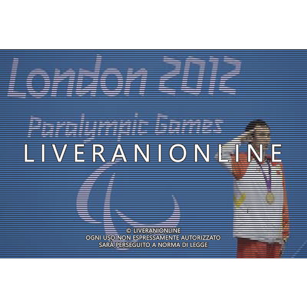 (120909) -- LONDON, Sept. 9, 2012 () -- Yang Bozun of China salutes during the awarding ceremony of the men\'s 200m individual medley SM11 final of swimming competition at the London 2012 Paralympic Games in London, Britain, on Sept. 8, 2012. Yang won the gold medal and created the new world record with 2 minutes and 22.40 seconds. (/Wu Wei) (lm) PHOTOSHOT/AG ALDO LIVERANI SAS - ITALY ONLY -