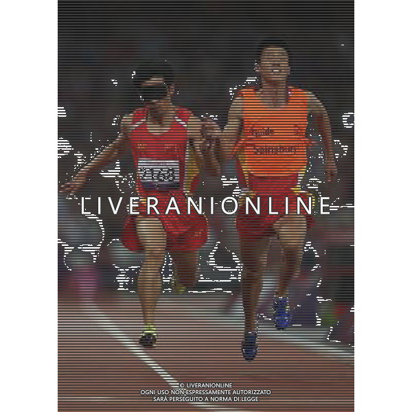 (120909) -- LONDON, Sept. 9, 2012 () -- Xue Lei (L) and guide Wang Lin of China compete during the men\'s 100m T11 final of athletics competition at the London 2012 Paralympic Games in London, Britain, on Sept. 8, 2012. Xue Lei won the gold with 11.17 seconds.(/Wang Lili) (lm) PHOTOSHOT/AG ALDO LIVERANI SAS - ITALY ONLY -