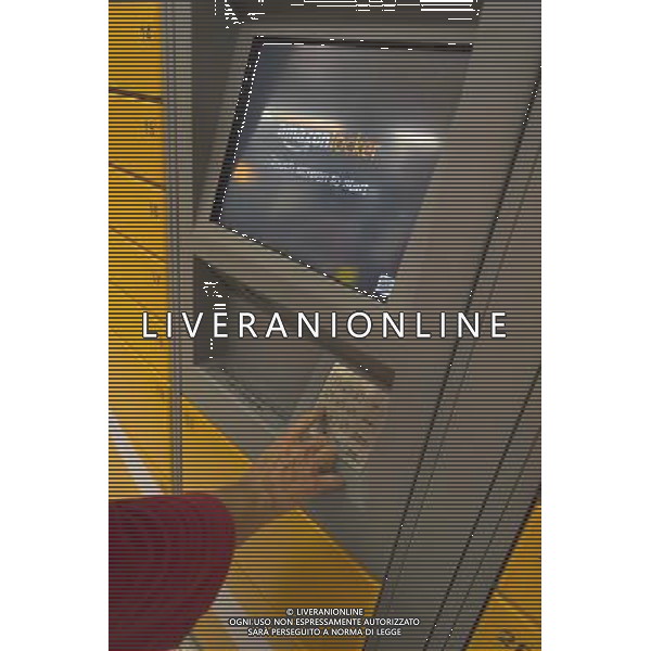 An Amazon customer picks up her package in an Amazon Locker in a supermarket New York on Tuesday, September 4, 2012. The lockers, placed in grocery and convenience stores in mostly urban areas, enable customers, who work and do not have doorman or another party, to receive their purchase in a secure location. When delivered the purchaser receives an email with a code which pops open a door in the locker. (å Richard B. Levine) photoshot/AG ALDO LIVERANI SAS - ITALY ONLY -