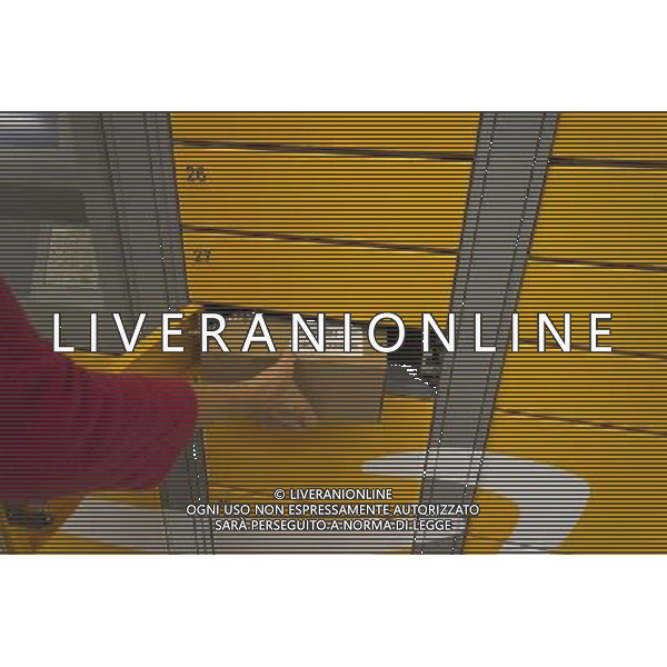 An Amazon customer picks up her package in an Amazon Locker in a supermarket New York on Tuesday, September 4, 2012. The lockers, placed in grocery and convenience stores in mostly urban areas, enable customers, who work and do not have doorman or another party, to receive their purchase in a secure location. When delivered the purchaser receives an email with a code which pops open a door in the locker. (å Richard B. Levine) photoshot/AG ALDO LIVERANI SAS - ITALY ONLY -