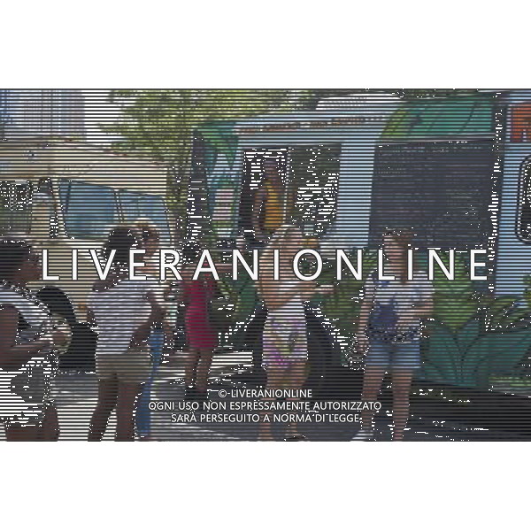 Hungry attendees to the AfroPunk Festival in Commodore Barry Park in Brooklyn in New York on Sunday, August 26, 2012 enjoy juice from Green Pirate truck the food truck festival. The festival in the neighborhood of Fort Greene bills itself as the \'other black experience\' and blends the black punk and hardcore punk scenes. There is also a diverse aspect combining other minority groups, all dressed in their fashionable punk ensembles. (å Richard B. Levine) ©photoshot/AGENZIA ALDO LIVERANI SAS - ITALY ONLY - EDITORIAL USE ONLY