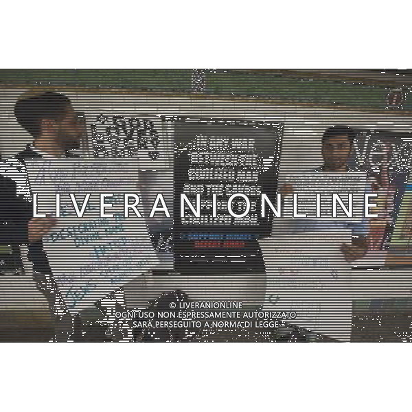 Rabbi Ari Hart, left, and his Muslim friend Anan Farooqui, right, protest an advertisement in the subway in New York supports Israel and promotes defeating Jihad, referring to Jihadists as savages, seen in the Times Square subway station on Monday, September 24, 2012. The controversial poster is from the American Freedom Defense Initiative, a group run by Pamela Geller who also runs the Stop Islamization of America group. Â©photoshot/Agenzia Aldo Liverani ITALY ONLY vedute citta\' di New York