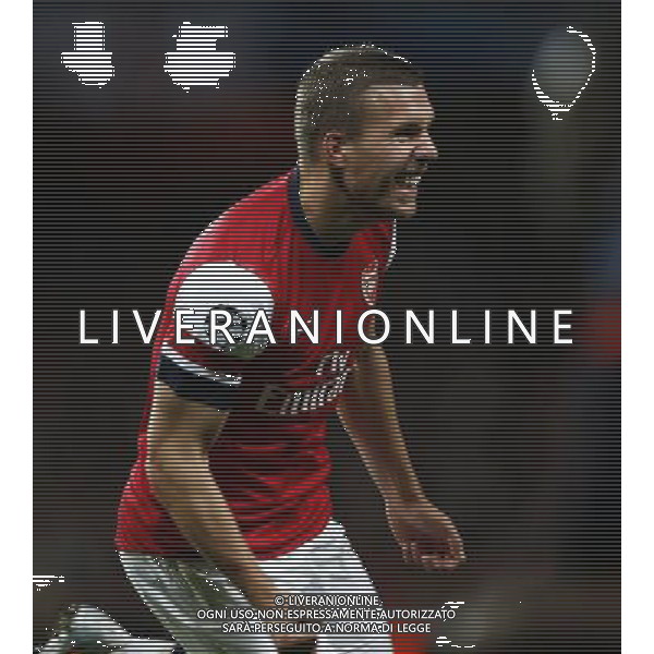 (121004) -- LONDON, Oct. 4, 2012 () -- Lukas Podolski of Arsenal celebrates scoring Arsenal\'s 2nd goal during the UEFA Champions League Group B match between Arsenal FC and Olympiacos FC at the Emirates Stadium in London, Britain on Oct. 3, 2012. Arsenal won 3-1. (/Wang Lili) ©PHOTOSHOT/AGENZIA ALDO LIVERANI SAS - ITALY ONLY - EDITORIAL USE ONLY