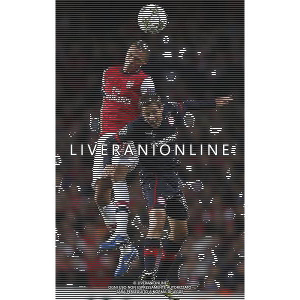 (121004) -- LONDON, Oct. 4, 2012 () -- Kieran Gibbs (L) of Arsenal heads with David Fuster of Olympiacos during the UEFA Champions League Group B match between Arsenal FC and Olympiacos FC at the Emirates Stadium in London, Britain on Oct. 3, 2012. Arsenal won 3-1. (/Wang Lili) ©PHOTOSHOT/AGENZIA ALDO LIVERANI SAS - ITALY ONLY - EDITORIAL USE ONLY