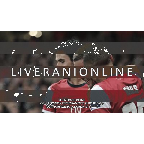 (121004) -- LONDON, Oct. 4, 2012 () -- Lukas Podolski (C) of Arsenal is congratulated by Mikel Arteta (L) and Kieran Gibbs after scoring Arsenal\'s 2nd goal during the UEFA Champions League Group B match between Arsenal FC and Olympiacos FC at the Emirates Stadium in London, Britain on Oct. 3, 2012. Arsenal won 3-1. (/Wang Lili) ©PHOTOSHOT/AGENZIA ALDO LIVERANI SAS - ITALY ONLY - EDITORIAL USE ONLY