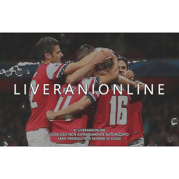 (121004) -- LONDON, Oct. 4, 2012 () -- Players of Arsenal celebrate scoring during the UEFA Champions League Group B match between Arsenal FC and Olympiacos FC at the Emirates Stadium in London, Britain on Oct. 3, 2012. Arsenal won 3-1. (/Wang Lili) ©PHOTOSHOT/AGENZIA ALDO LIVERANI SAS - ITALY ONLY - EDITORIAL USE ONLY