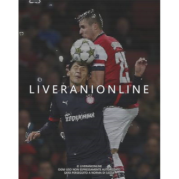 (121004) -- LONDON, Oct. 4, 2012 () -- Carl Jenkinson (top) of Arsenal heads with Marko Pantelic of Olympiacos during the UEFA Champions League Group B match between Arsenal FC and Olympiacos FC at the Emirates Stadium in London, Britain on Oct. 3, 2012. Arsenal won 3-1. (/Wang Lili) ©PHOTOSHOT/AGENZIA ALDO LIVERANI SAS - ITALY ONLY - EDITORIAL USE ONLY