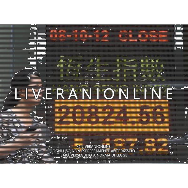 (121008) -- HONG KONG, Oct. 8, 2012 () -- A pedestrian walks past an electronic board showing the Hang Seng Index in south China\'s Hong Kong, Oct. 8, 2012. Hong Kong\'s benchmark Hang Seng Index fell 187.2 points on Monday to close at 20824.56 points. (/Wong Pun Keung) (lmm) ©photoshot/AGENZIA ALDO LIVERANI SAS - ITALY ONLY - Tabellone elettronico che mostra l\'indice della Borsa - Cina