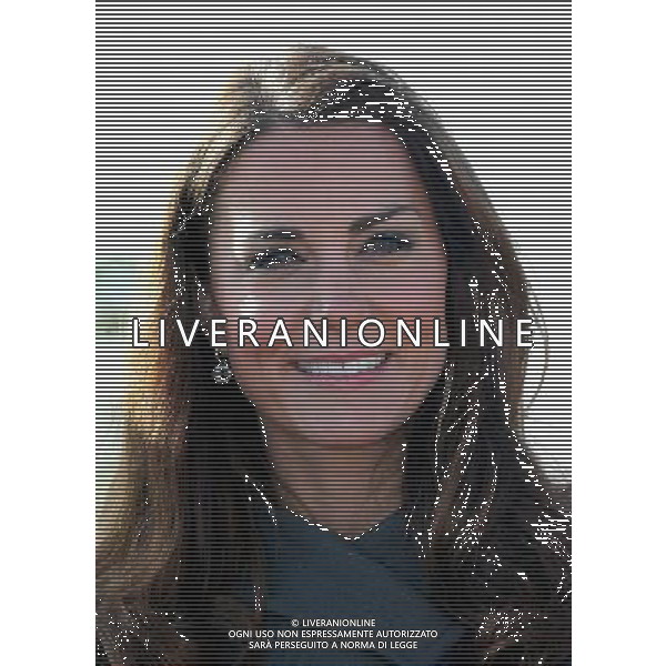 BURTON-UPON-TRENT, ENGLAND - OCTOBER 09: Catherine, Duchess of Cambridge smiles during the official launch of The Football Association\'s National Football Centre at St George\'s Park on October 9, 2012 in Burton-upon-Trent, England. ( ©photoshot/AGENZIA ALDO LIVERANI SAS - ITALY ONLY - REALI INGLESI: Il principe William e la moglie Kate Middleton alla presentazione ufficiale di The Football Association National Football Centre al Parco di San Giorgio a Burton upon Trent, Inghilterra 09/10/2012. 