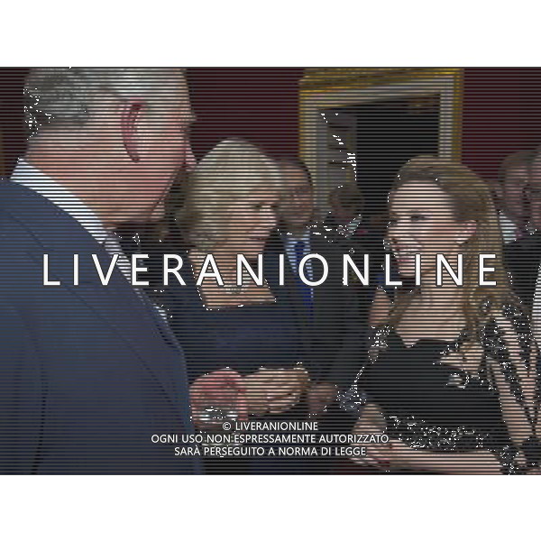 Australian pop singer, Kylie Minogue (R), meets Britain\'s Prince Charles and his wife Camilla, Duchess of Cornwall at St James\'s Palace in central London on October 24, 2012, during a reception for prominent Papua New Guineans, Australians and New Zealanders living in the UK ahead of their tour Papua New Guinea, Australia and New Zealand. ©photohsot/AGENZIA ALDO LIVERANI SAS - ITALY ONLY - REALI INGLESI: Il principe Carlo d\'inghilterra e la moglie Camilla, duchessa di Cornovaglia durante un ricevimento per le comunita\' Papua Nuova Guinea, australiana e neozelandese che vivono nel Regno Unito, presso il Palazzo San Giacomo nel centro di Londra il 24 ottobre 2012