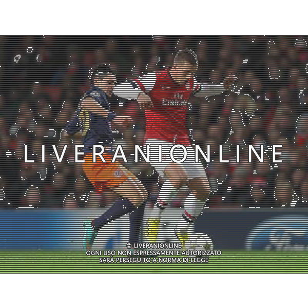 Arsenal\'s Lukas Podolski shields the ball from Montpellier\'s Remy Cabella ..Football - UEFA Champions League Group B - Arsenal v Montpellier - Wednesday 21st November 2012 - Emirates Stadium - London.. AG ALDO LIVERANI S A S ONLY ITALY