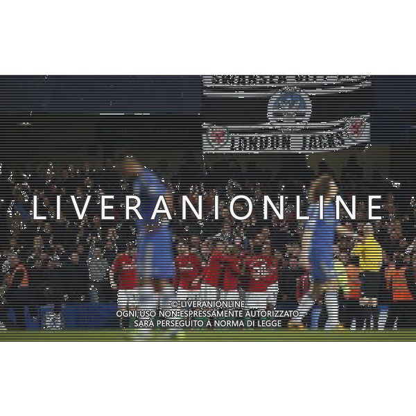 (130110) -- LONDON, Jan. 10, 2013 () -- Players of Swansea celebrate with fans after scoring during the English League Cup (Capital One Cup) semifinal first leg between Chelsea and Swansea at Stamford Bridge in London, Britain, on Jan. 9, 2013. Chelsea lost 0-2. (/Wang Lili) FOR EDITORIAL USE ONLY. NOT FOR SALE FOR MARKETING OR ADVERTISING CAMPAIGNS. NO USE WITH UNAUTHORIZED AUDIO, VIDEO, DATA, FIXTURE LISTS, CLUB/LEAGUE LOGOS OR \'LIVE\' SERVICES. ONLINE IN-MATCH USE LIMITED TO 45 IMAGES, NO VIDEO EMULATION. NO USE IN BETTING, GAMES OR SINGLE CLUB/LEAGUE/PLAYER PUBLICATIONS. AG ALDO LIVERANI S A S ONLY ITALY