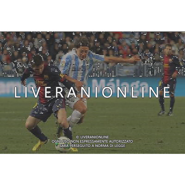 (130125) -- MALAGA, Jan. 25, 2013 () -- Barcelona\'s Lionel Messi (L) vies with a player of Malaga during their Spanish King\'s Cup quarterfinal second leg soccer match held at Rosaleda stadium in Malaga, Spain, on Jan. 24, 2013. Barcelona won 4-2. (/) ©photoshot/AGENZIA ALDO LIVERANI SAS - ITALY ONLY - MALAGA VS BARCELLONA partita dei quarti di finale della Coppa del re presso Rosaleda stadio a Malaga, in Spagna, 24 gennaio 2013. Il Barcellona ha vinto 4-2. 