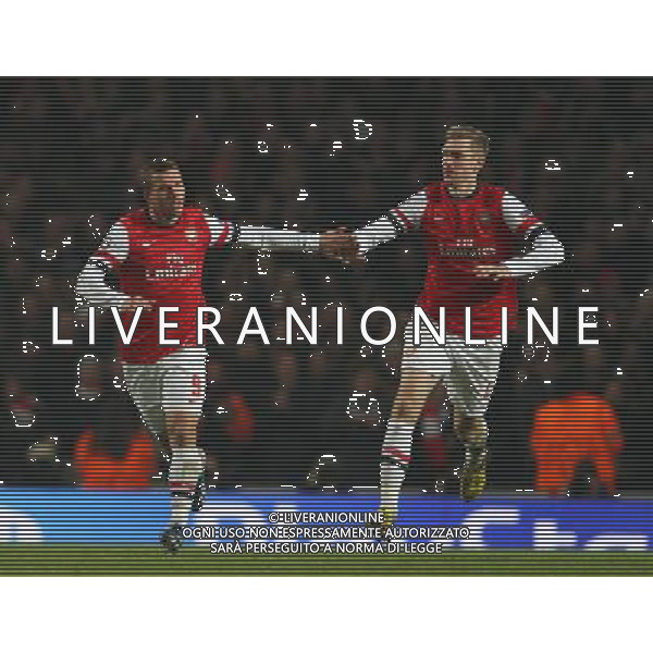 LUKAS PODOLSKI CELEBRATES HIS GOAL WITH THOMAS VERMAELEN ARSENAL V BAYERN MUNICH ARSENAL V BAYERN MUNICH. UEFA CHAMPIONS LEAGUE EMIRATES STADIUM, LONDON, ENGLAND, UK 19 February 2013 GAQ65994 WARNING! This Photograph May Only Be Used For Newspaper And/Or Magazine Editorial Purposes. May Not Be Used For Publications Involving 1 player, 1 Club Or 1 Competition Without Written Authorisation From Football DataCo Ltd. For Any Queries, Please Contact Football DataCo Ltd on +44 (0) 207 864 9121 AG ALDO LIVERANI S A S ONLY ITALY