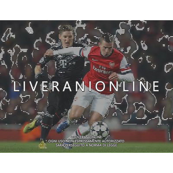 Arsenal\'s Lukas Podolski shields the ball from Bayern Munich\'s Bastian Schweinsteiger - Credit - CameraSport - KARYN HADDON - Football - UEFA Champions League Round of 16 First Leg - Arsenal v Bayern Munich - Tuesday 19th February 2013 - Emirates Stadium - London © CameraSport - 43 Linden Ave. Countesthorpe. Leicester. England. LE8 5PG - Tel: +44 (0) 116 277 4147 - admin@camerasport.com - www.camerasport.com AG ALDO LIVERANI S A S ONLY ITALY